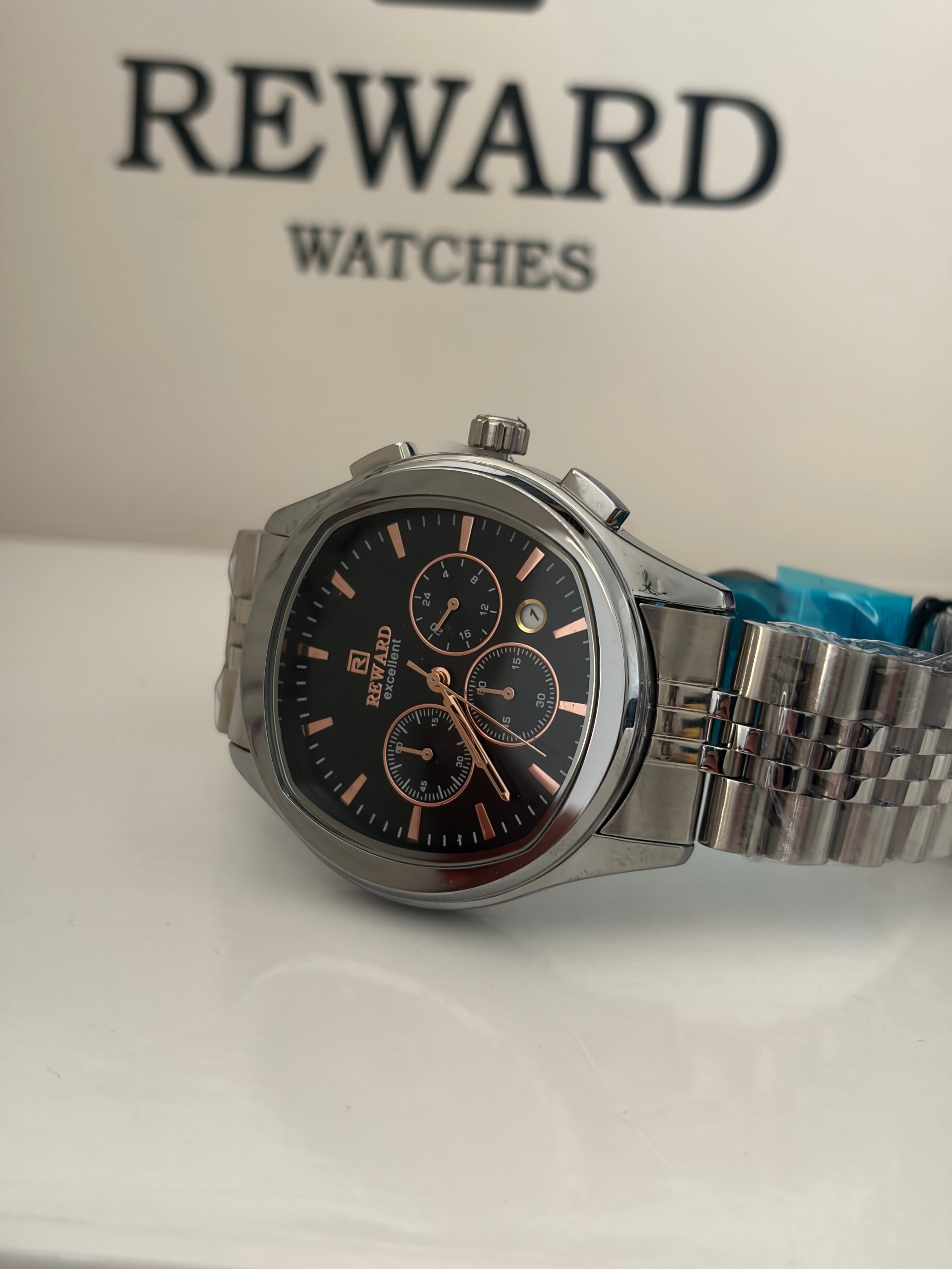 Reward Watches Maestro Noir Argent chronograph watch with black dial, rose gold indices, and stainless steel case and bracelet.