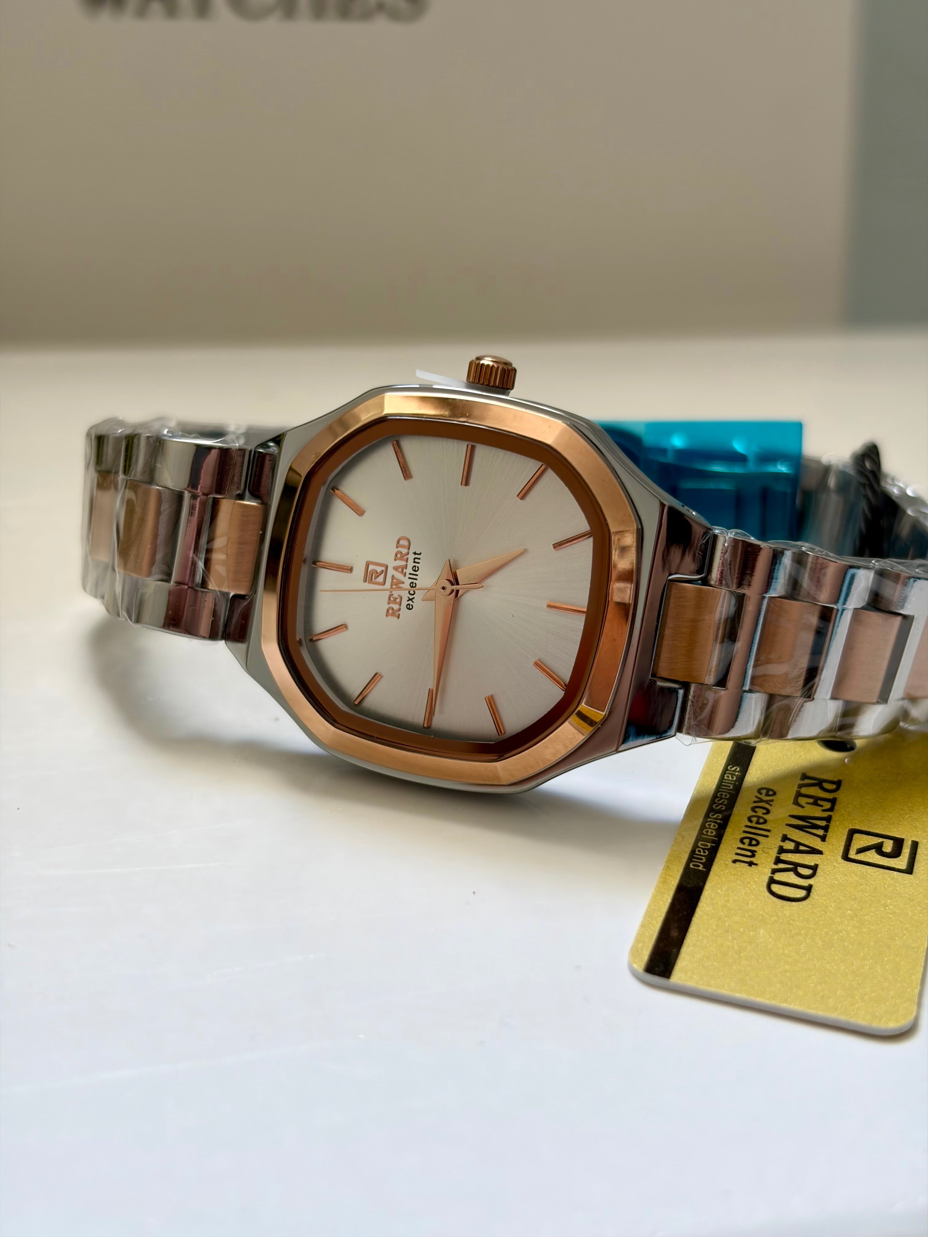 Reward Watches rose gold octagonal watch with silver stainless steel band and white dial with rose gold indices.